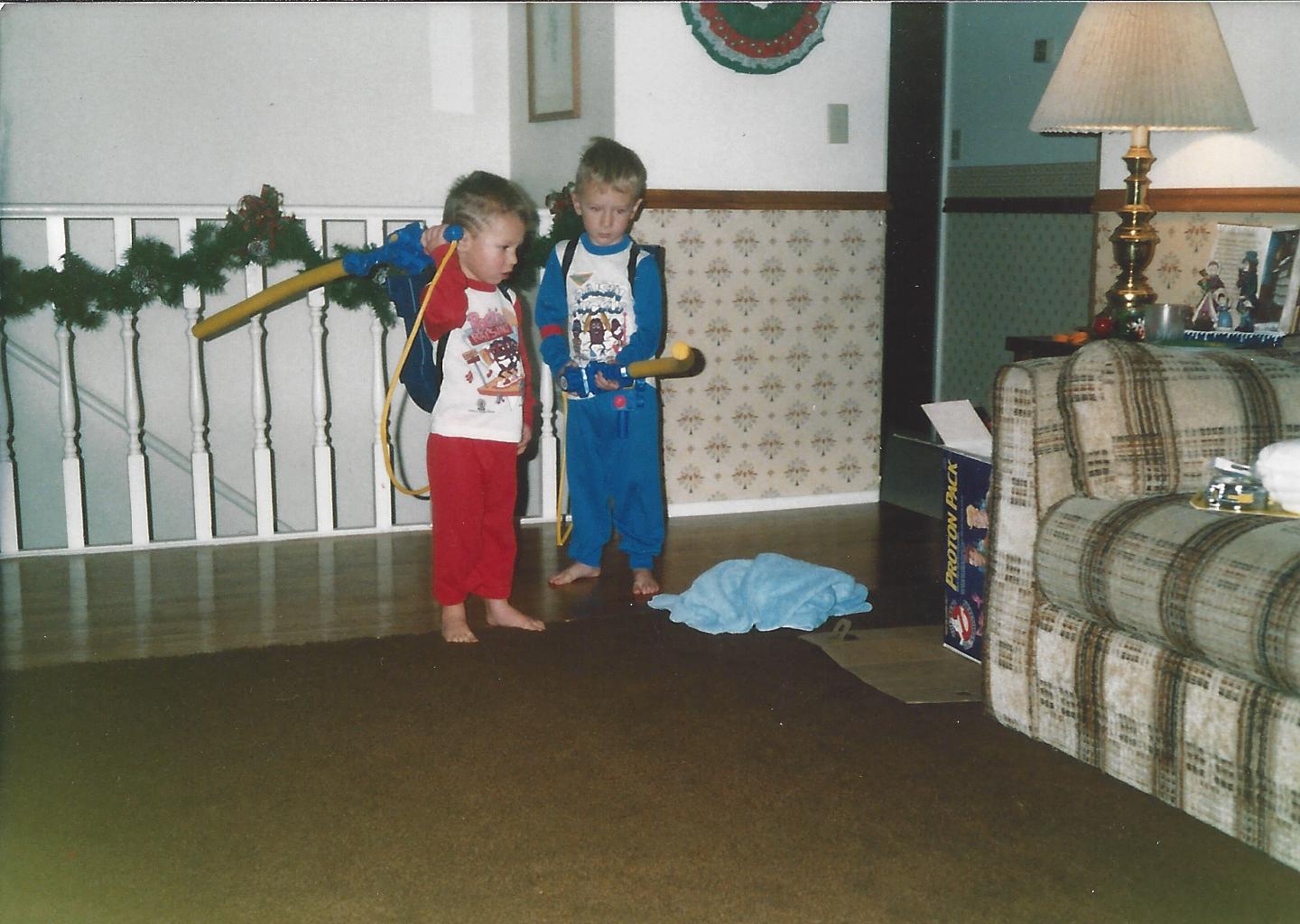 Two boys with Ghostbusters Proton Pack toys, Christmas morning